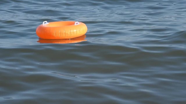 Orange Swim Ring On The Sea Surface