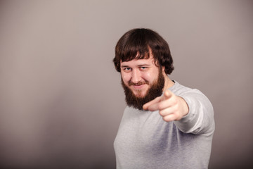 Fototapeta premium Businessman pointing left hand not straight forward on dark background
