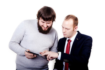 Business people planning work in office working on tablet computer, left guy shows to another man his plan