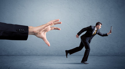 Businessman running from hand
