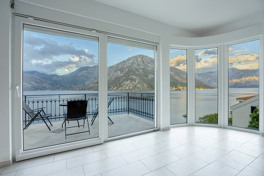 Panoramic window in a living room in a villa with beautiful mountain and sea view