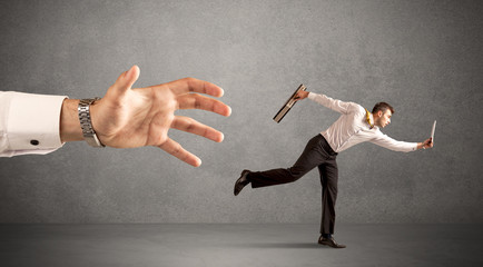 Businessman running from hand