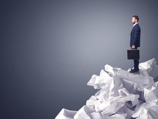 Businessman standing on crumpled paper