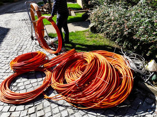 Orange fibre or fiber optic cables at garden for excavation