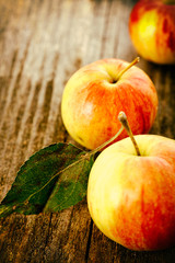 Ripe red apples on wooden background