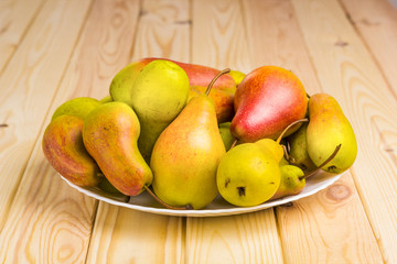 Ripe pears in a plate. 