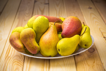 Ripe pears in a plate. 