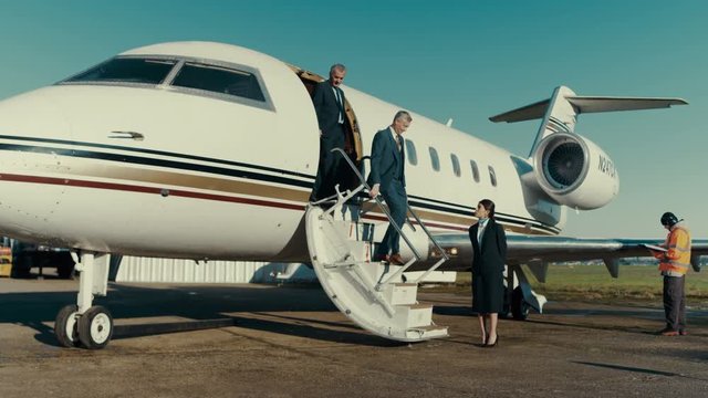  Mixed ethnicity VIP Businessmen disembarking from private jet