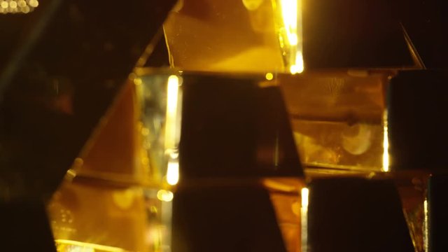  Close up gold bars on shimmering rotating stand, wealth & luxury concept.