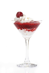 Raspberry puree with whipped cream and a raspberry