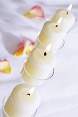 Burning candles on a white table cloth