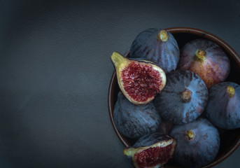 Fresh fruits, ripe fall figs in a clay bowl