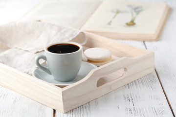 details of living room. Cup of coffee on rustic wooden tray