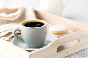 Obraz na płótnie Canvas cup of espresso or coffee resting on a white serving tray