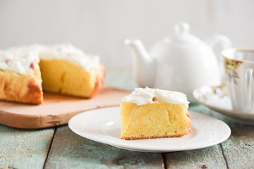 Dessert and tea. Teapot and piece of cake with apples and cream cheese on shabby robin egg blue background