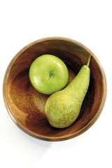 Green fruit: apple and pear in a wooden bowl