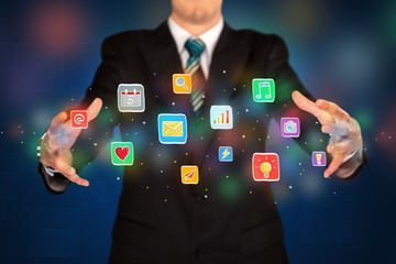 Businessman holding application icons