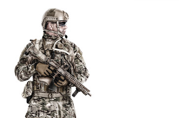 Half length low angle studio shot of special forces soldier in field uniforms with weapons, portrait isolated on white background lot of copyspace. Protective goggles glasses are on