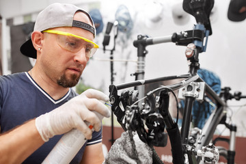 Mechanic repairing bicycle in his workshop