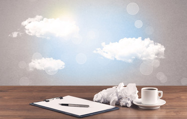 Bright sky with clouds and office desk