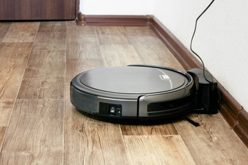 robot vacuum cleaner on the parquet floor