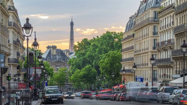 Sun setting behind a building on a Parisian Soufflot street timelapse with Eiffe tower on background