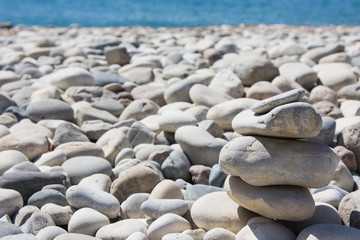Stack of pebbles balance harmony zen on Love Beach, Aphrodite's Rock - Aphrodite's birthplace near Paphos City