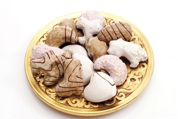 Frosted gingerbread cookies on an ornate golden plate