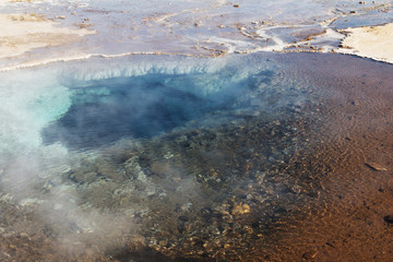 Iceland landscape. Steaming geothermal sources water. Famous geologic features and natural phenomena