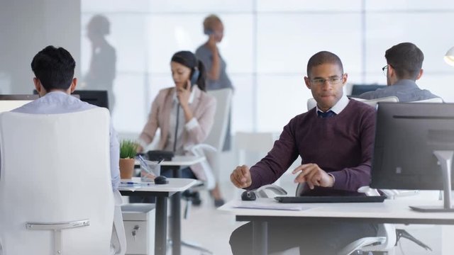  Business team including pregnant woman working together in office