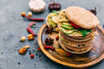 Variety of mini sandwiches with vegetableson a light background, top view. Flat lay