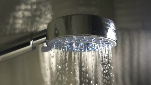 Shower head in bathroom. Slow motion