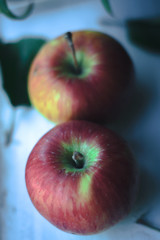 Fresh apples on a white wooden background.
