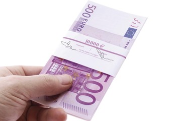 Hand holding a wad of euro banknotes