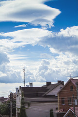 Fototapeta premium Rich houses against the blue sky with white clouds.