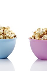 Popcorn in two coloured plastic bowls