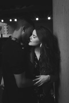 Young Male And Female Couple Kissing In The Street - Black And White