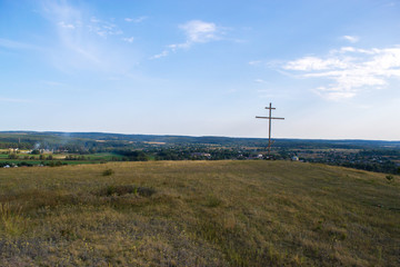 Autumn landscape on the mountain wooden cross.