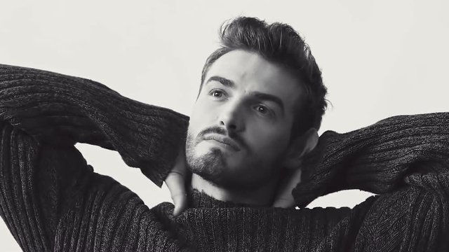 Passionate look at camera of handsome man in pose. Black and white. Slowly