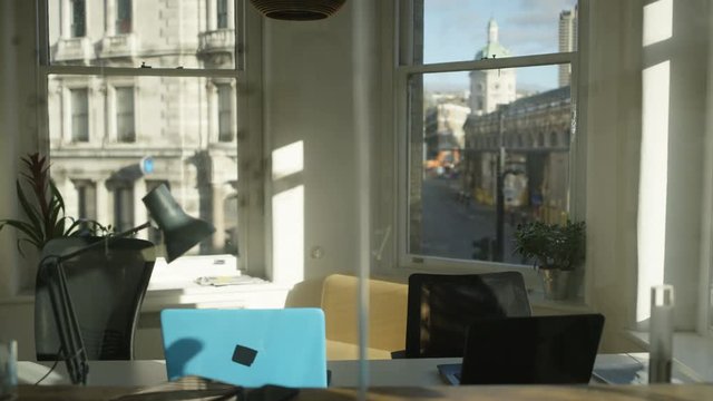  Interior of empty city office with inspirational quote written on glass scree