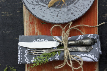 A circle made out of the christmas tree toys with text space in the center on a dark wooden background