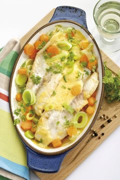 Fish casserole: ocean perch filets on a bed of vegetables scalloped with herbs and cheese