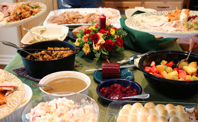 Casual Thanksgiving Feast on Table with Plates Being Filled - 175653032