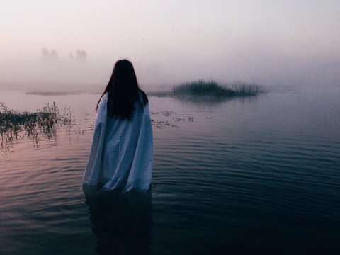 Woman in lake at sunrise