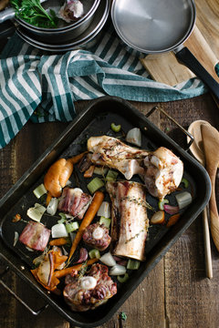 Roasted beef and oxtail bones in an oven tray.