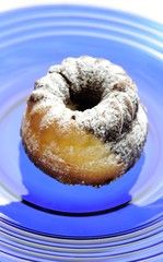 Marble cake with icing sugar on a blue plate