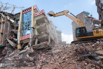 An excavator clearing off debris.