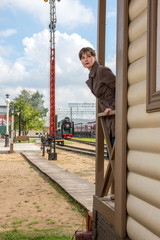 young woman waiting for train at station