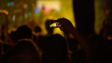 Making photo, video with cell phone at live music concert, festival