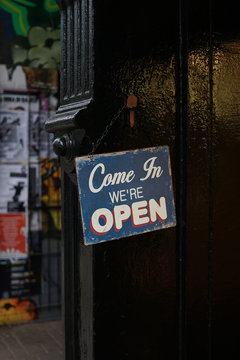 "Come in we're open" sign outside a shop